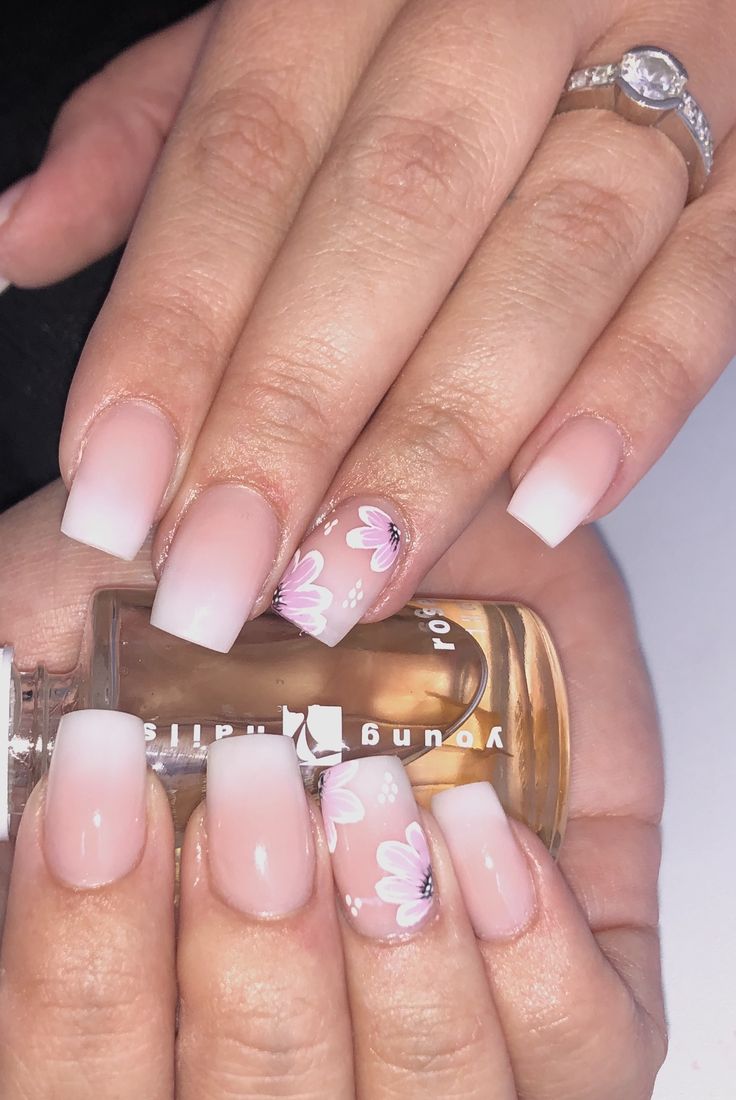 Elegant Ombre Nail Design with Floral Accents for a Charming Touch.