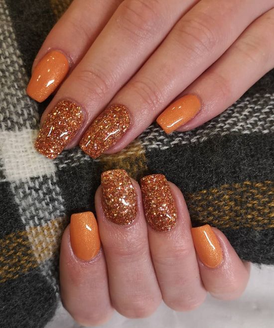 Playful Elegant Orange Nail Design with Glossy and Glitter Finishes for Fall Celebrations.