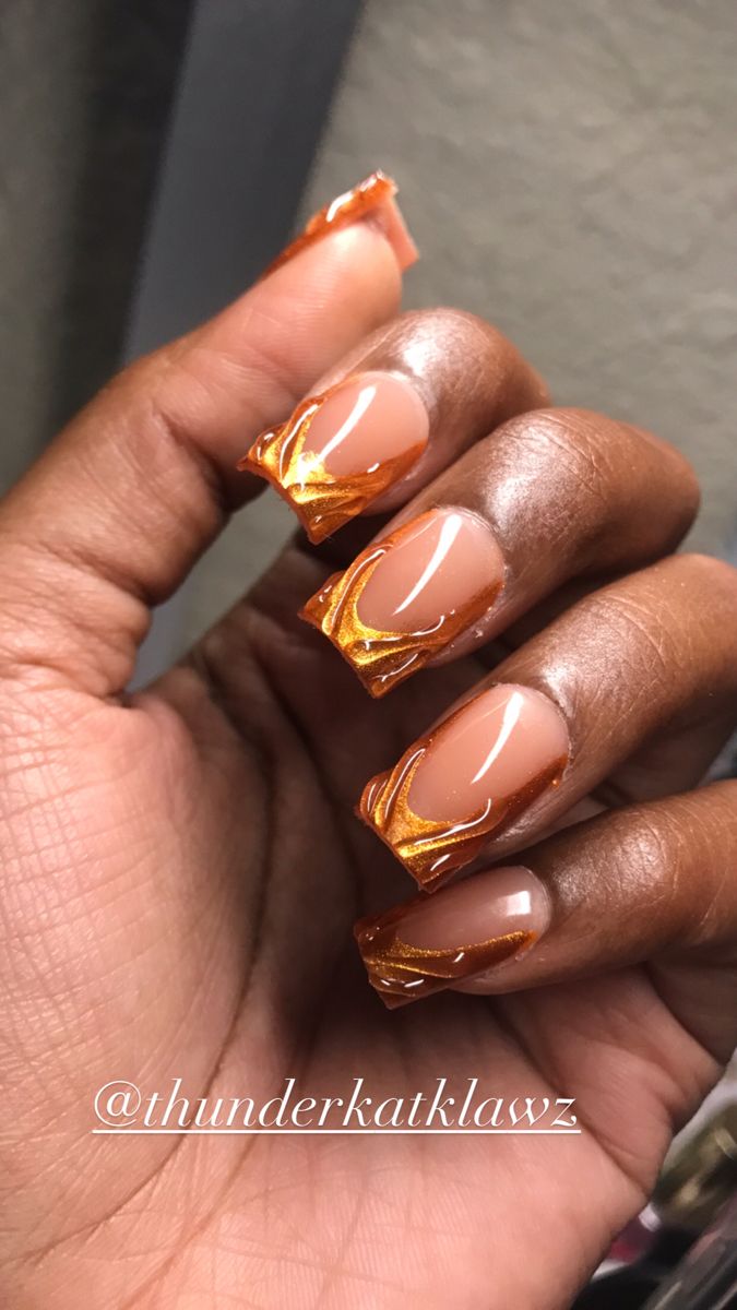 Elegant Nude Nail Design with Vibrant Orange Swirls and Glossy Finish.