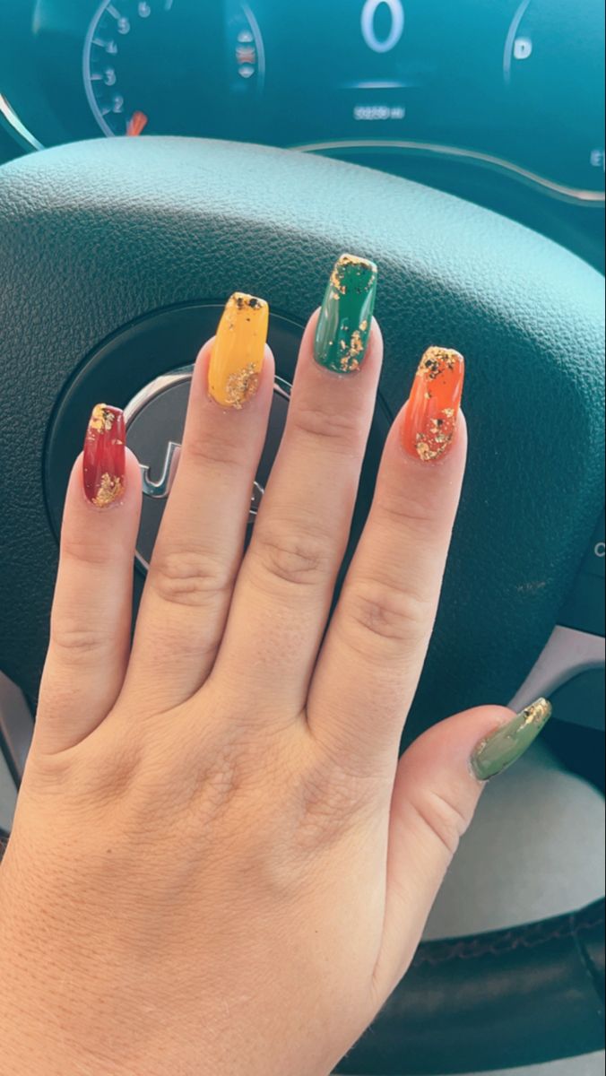 Vibrant Colorful Nail Design with Red, Yellow, Green, and Gold Accents