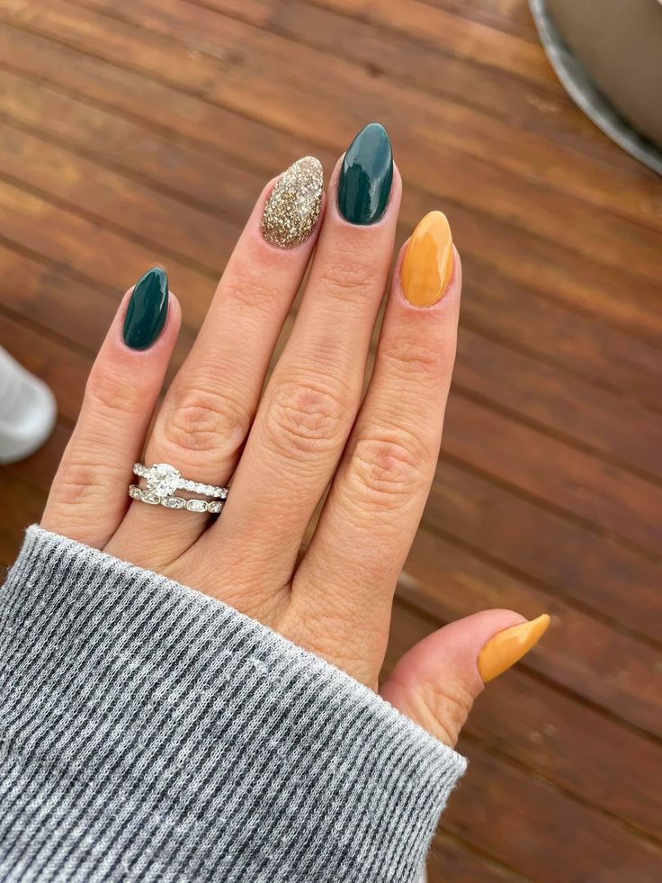 Eye-Catching Colorful Nail Design with Deep Green, Vibrant Yellow, and Shimmering Gold Accents.