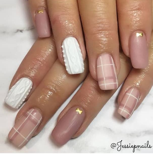 Chic Nail Design: Soft Pink and White with Textured Patterns and Gold Accents.