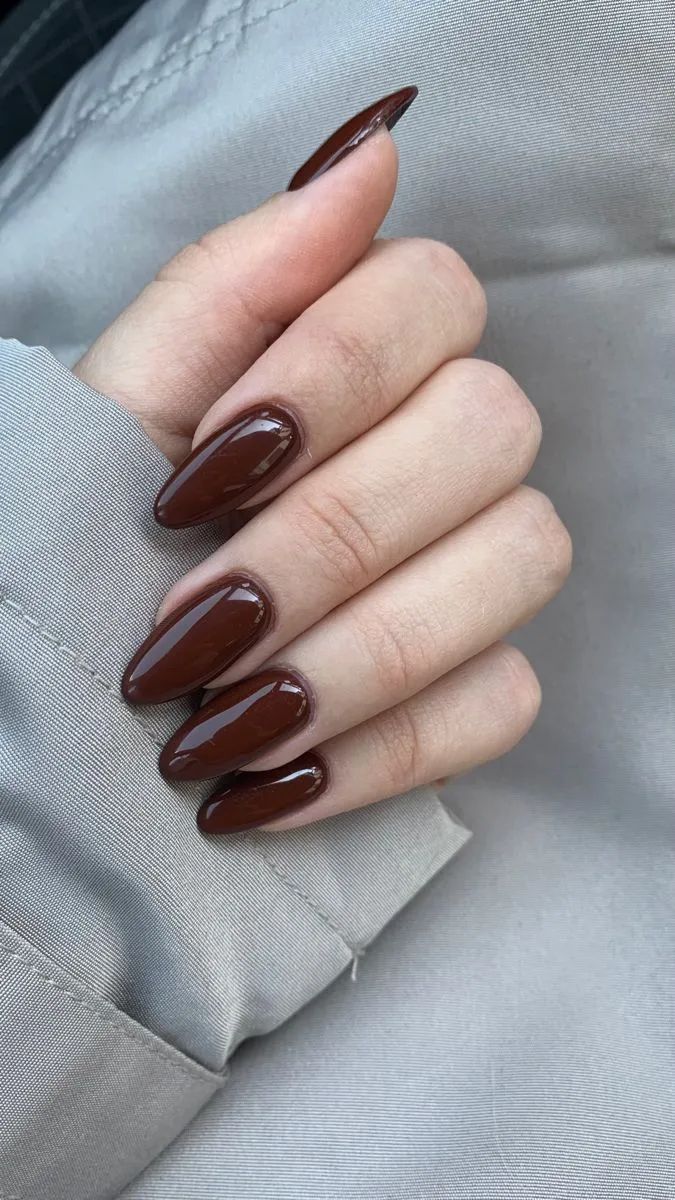 Sophisticated Almond-Shaped Nails in Deep Brown: Versatile Chic for Any Occasion.