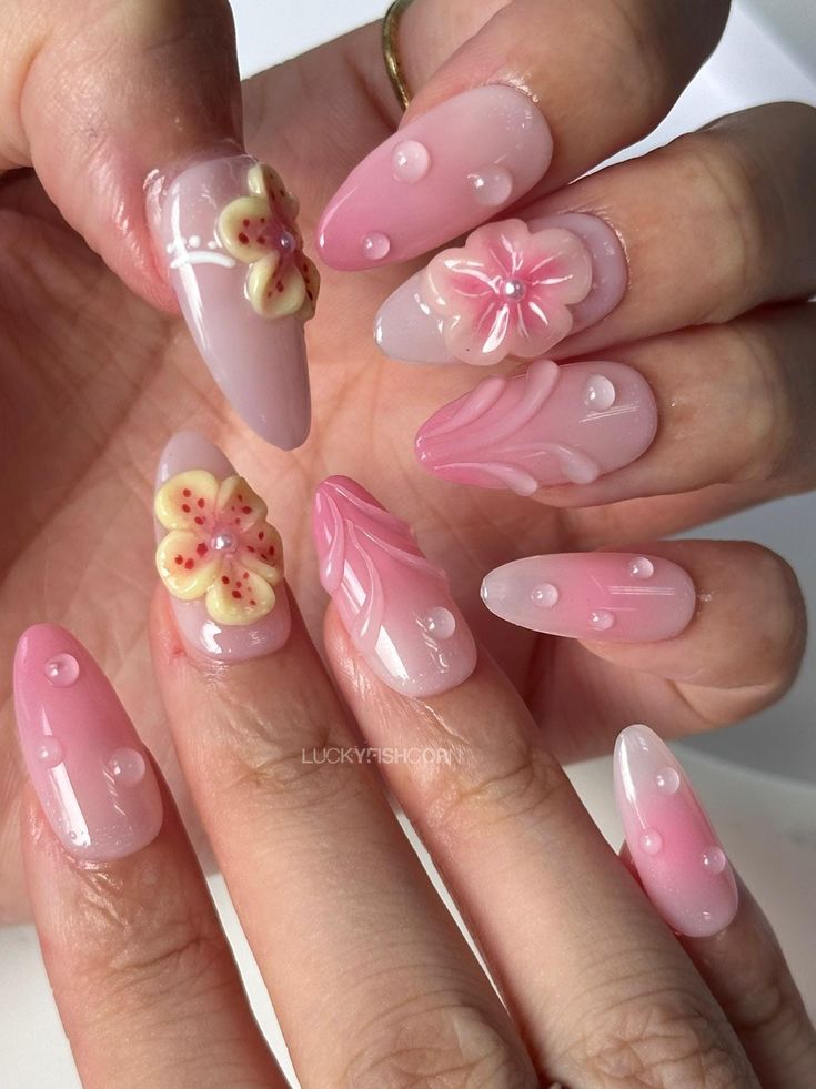 Elegant Floral Nail Art with a Delicate Pink Palette and Textured Details.