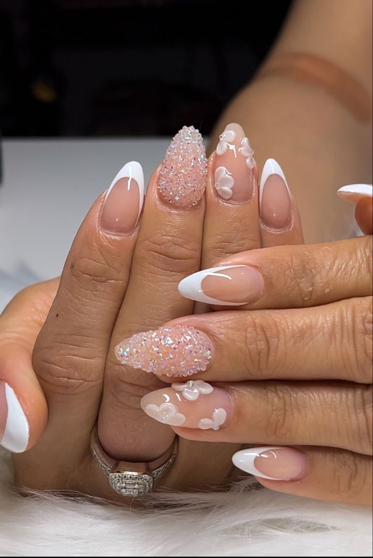 Chic French Tips with Sparkly Glitter and Whimsical Floral Accents.