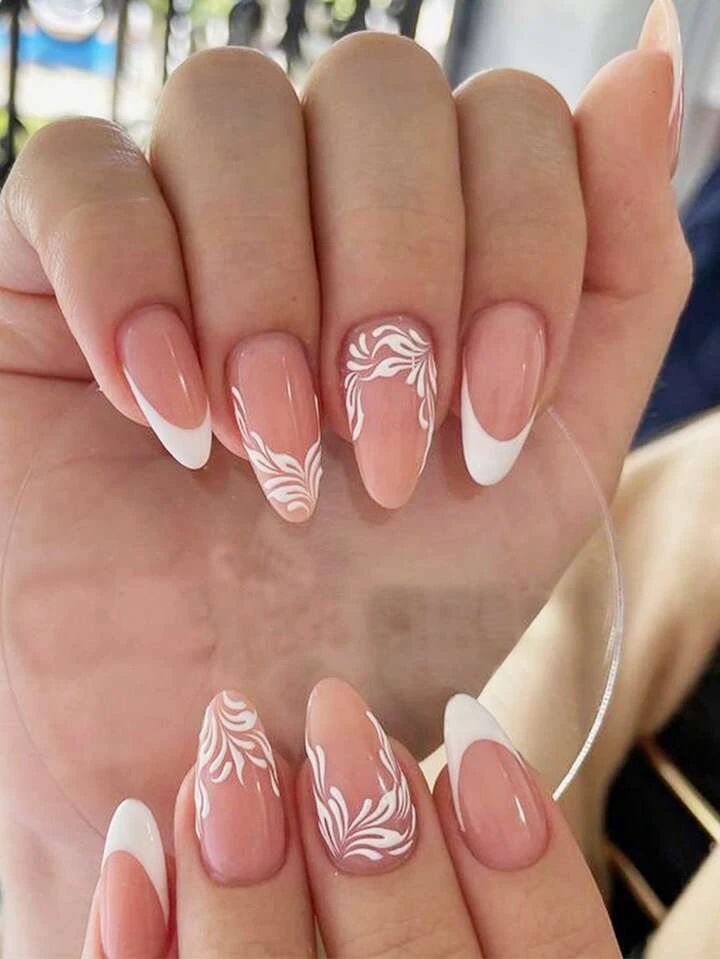 Chic Almond-Shaped Nail Design with Floral Patterns in Soft Pink and Crisp White.