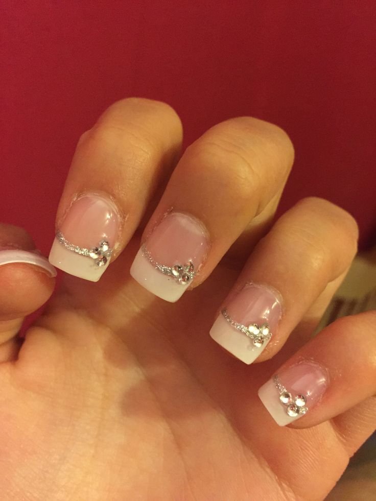 Glamorous French Manicure with White Tips, Soft Pink Base, Silver Chains, and Rhinestones