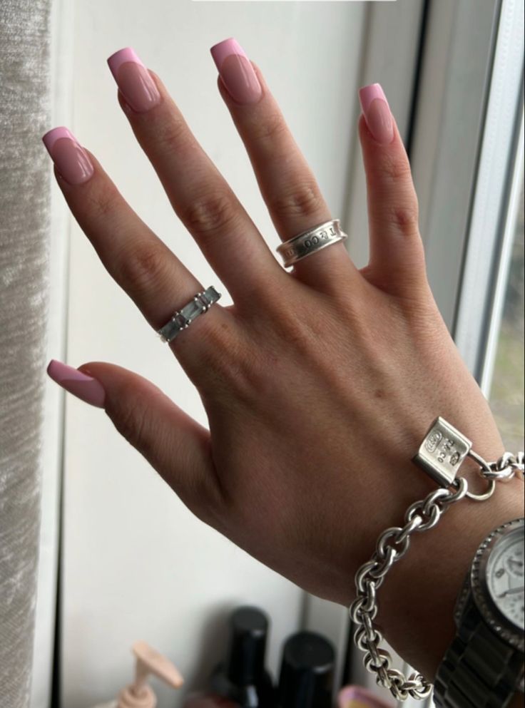 Elegant Soft Pink Square Nails Enhanced by Sleek Silver Accessories.