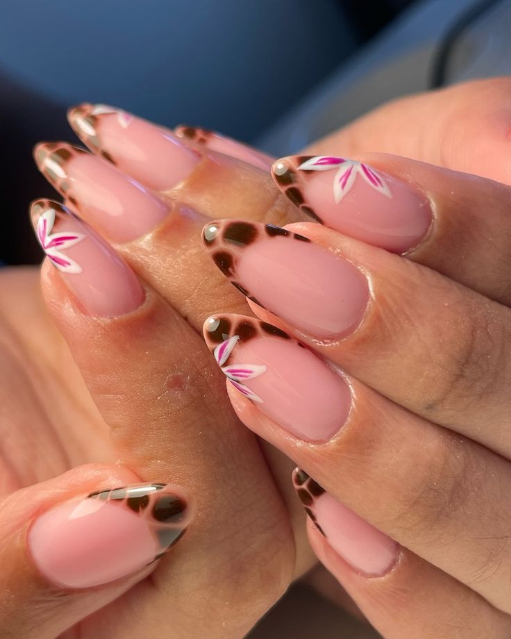 Chic Pink Nail Design with Bold Leopard Tips and Elegant Floral Accents.