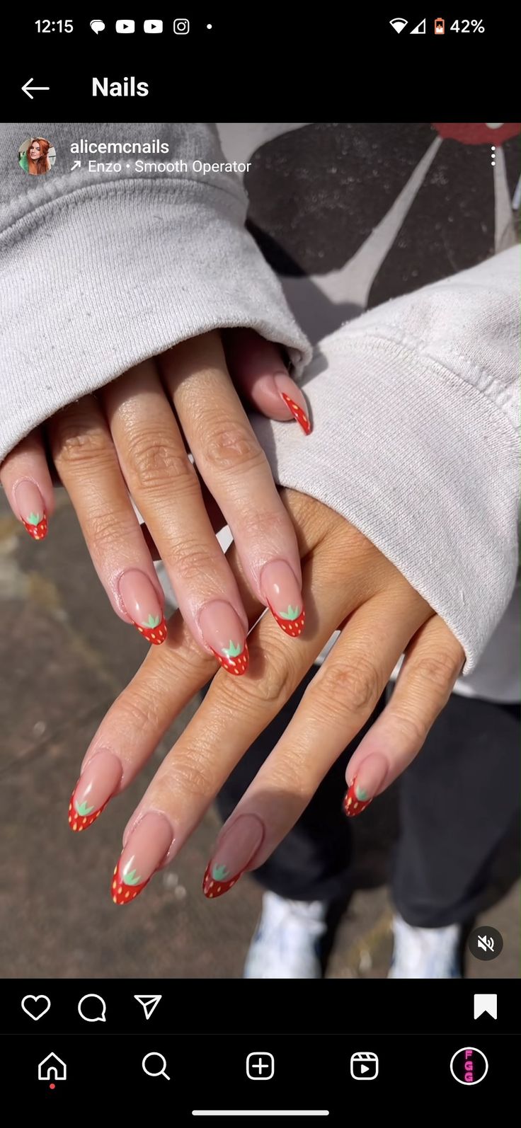 Playful Fruit-Inspired Nail Design with Strawberry Motif on Nude Base.