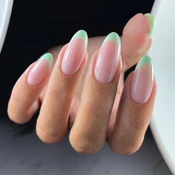 Modern Almond Nail Design: Soft Pink Base with Vibrant Green Tips