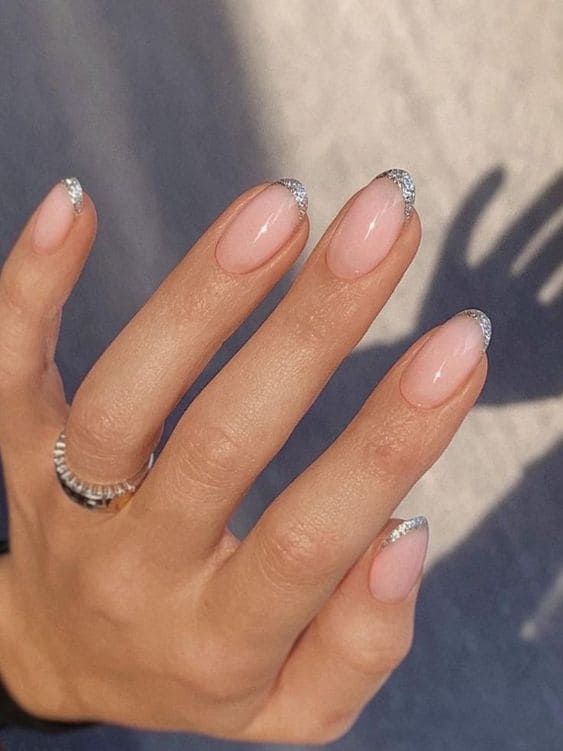 Chic Nude Nail Design with Sparkling Silver Tips for a Sophisticated Look.