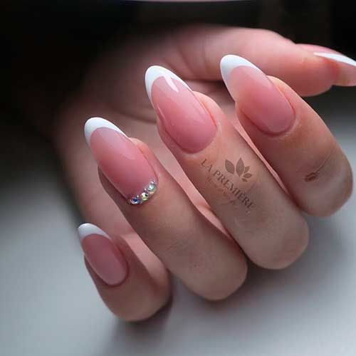 Timeless French Tip Nails with Soft Pink Base and Elegant Rhinestone Accent