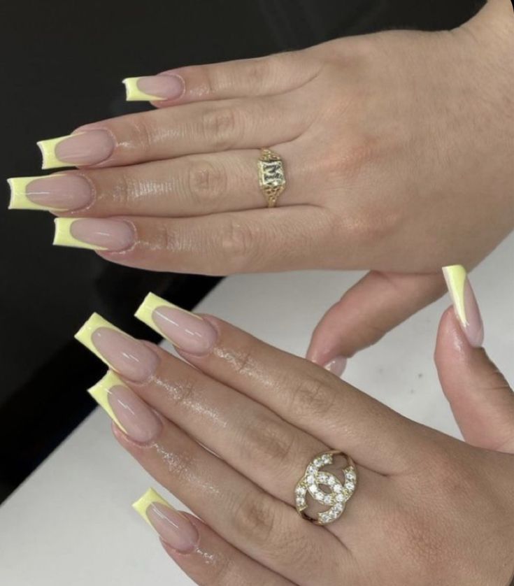 Chic French Tip Nail Design with Vibrant Yellow Accents and Stylish Accessories