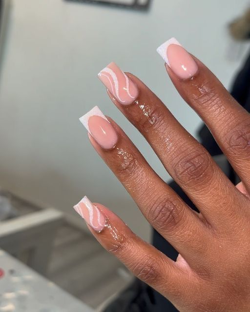 Elegant Soft Pink and White French Tip Nail Design with Artistic Swirls.