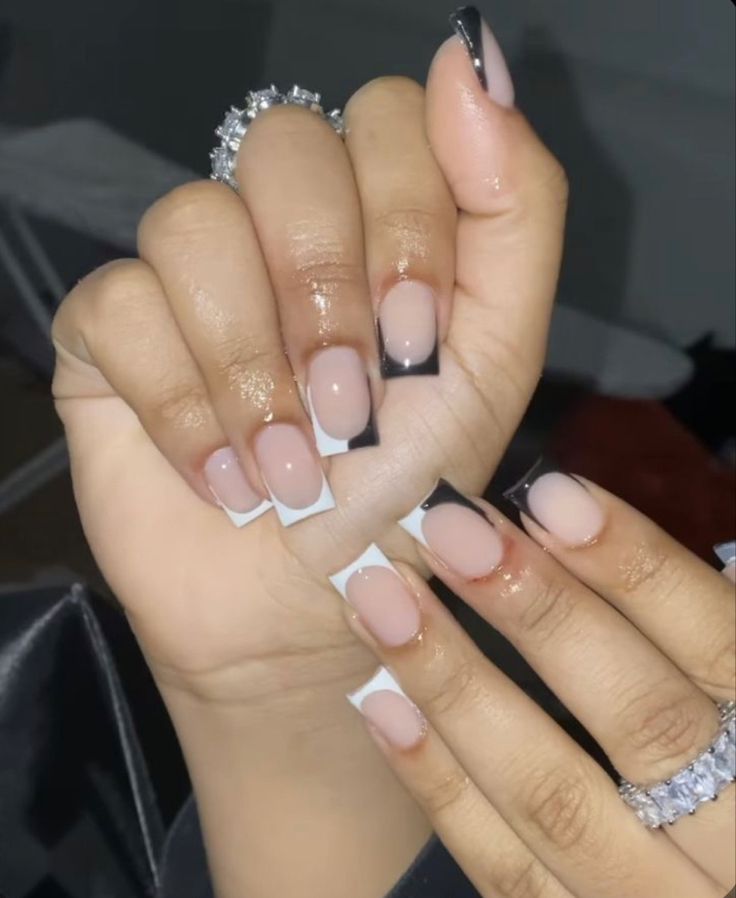 Chic Nail Design: Nude Base with Bold Black and White Tips