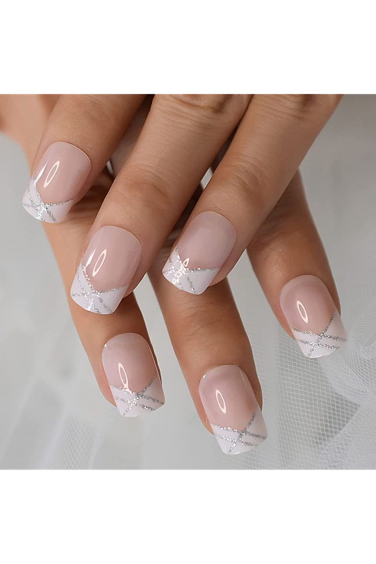 Chic Soft Nude Nail Design with Delicate White French Tips and Intricate Silver Detailing