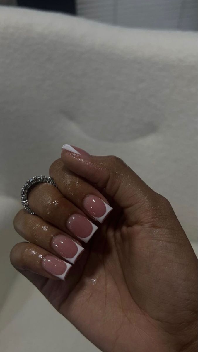 Sophisticated Soft Pink French Manicure with White Tips and Elegant Ring.