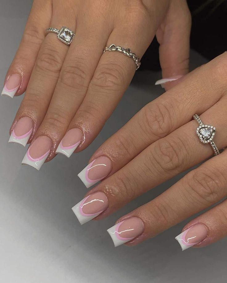 Chic French-Tip Nail Design with Soft Pink Accents and Glossy Finish.