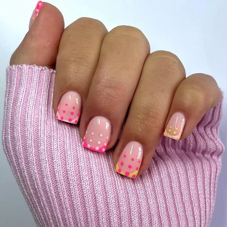 Whimsical Soft Pink Nail Design with Vibrant Polka Dots