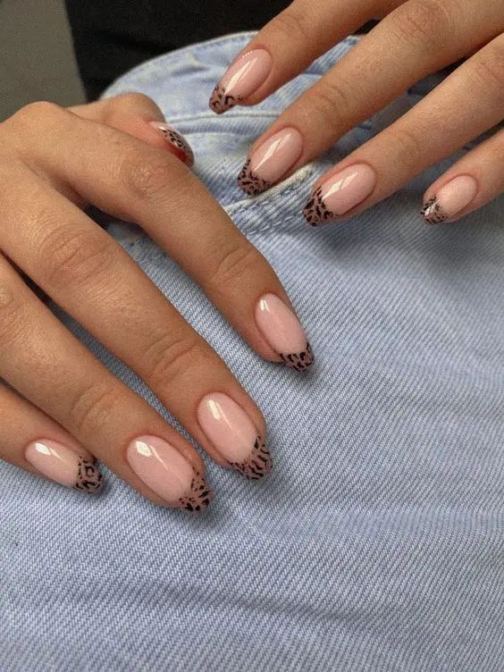 Elegant Pink Base with Bold Leopard Print Tips for a Playful Manicure.