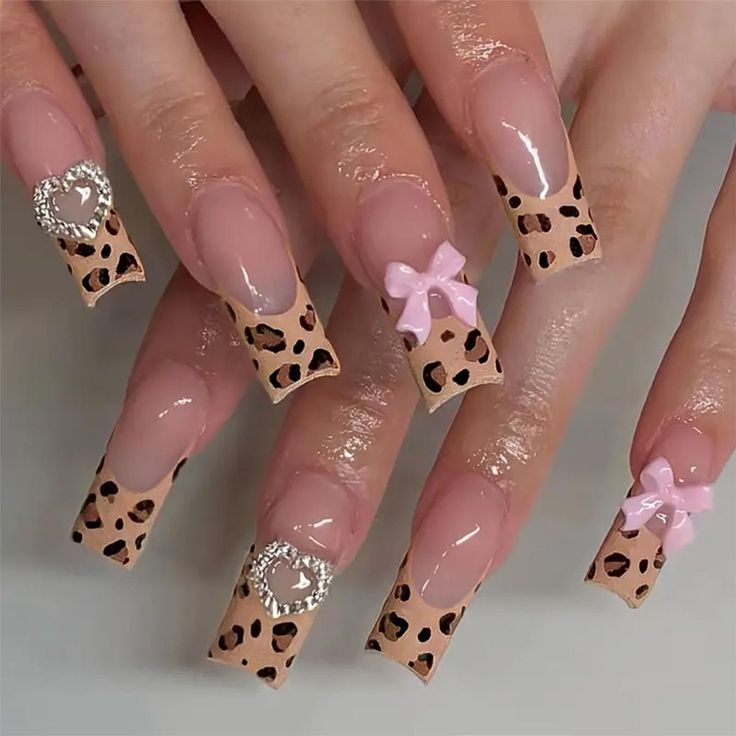 Trendy Leopard Print Statement Nails with Playful Pink Bows and Sparkling Accents.