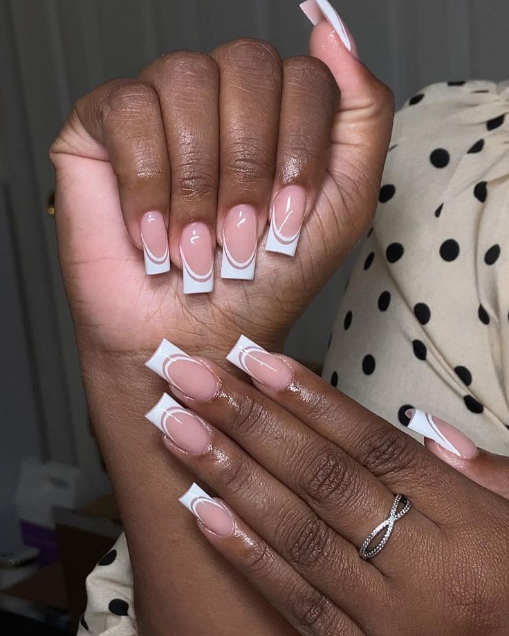 Sophisticated French Tip Nail Design with Elegant Nude Base and Delicate Ring Accents.