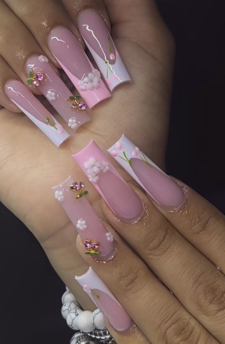 Chic Feminine Nail Design with Soft Pink, White, Floral Embellishments, and Metallic Accents.