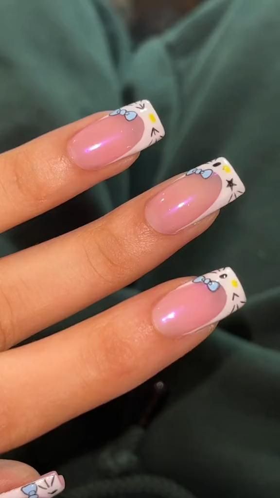 Whimsical Soft Pink Nail Design with Illustrated White Tips and Blue Accents