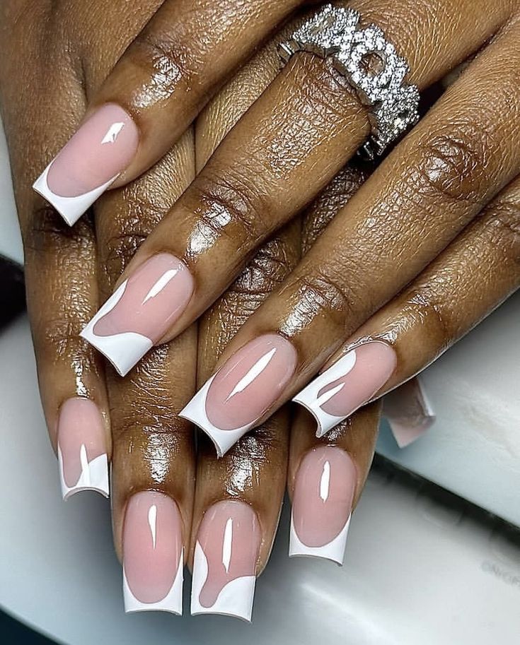 Modern Elegance: Soft Pink Base with Artistic Wavy White Tips for a Chic French Manicure.