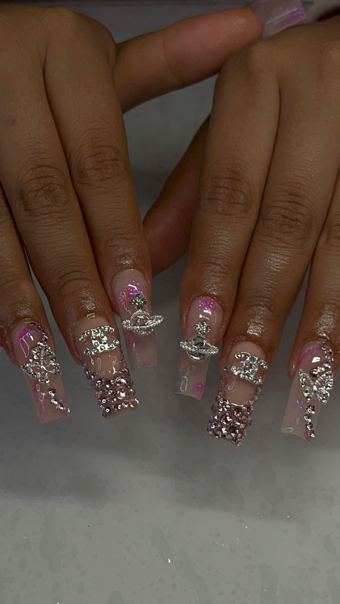 Chic and Eye-Catching Long Clear Acrylic Nails with Intricate Silver and Pink Rhinestone Embellishments.