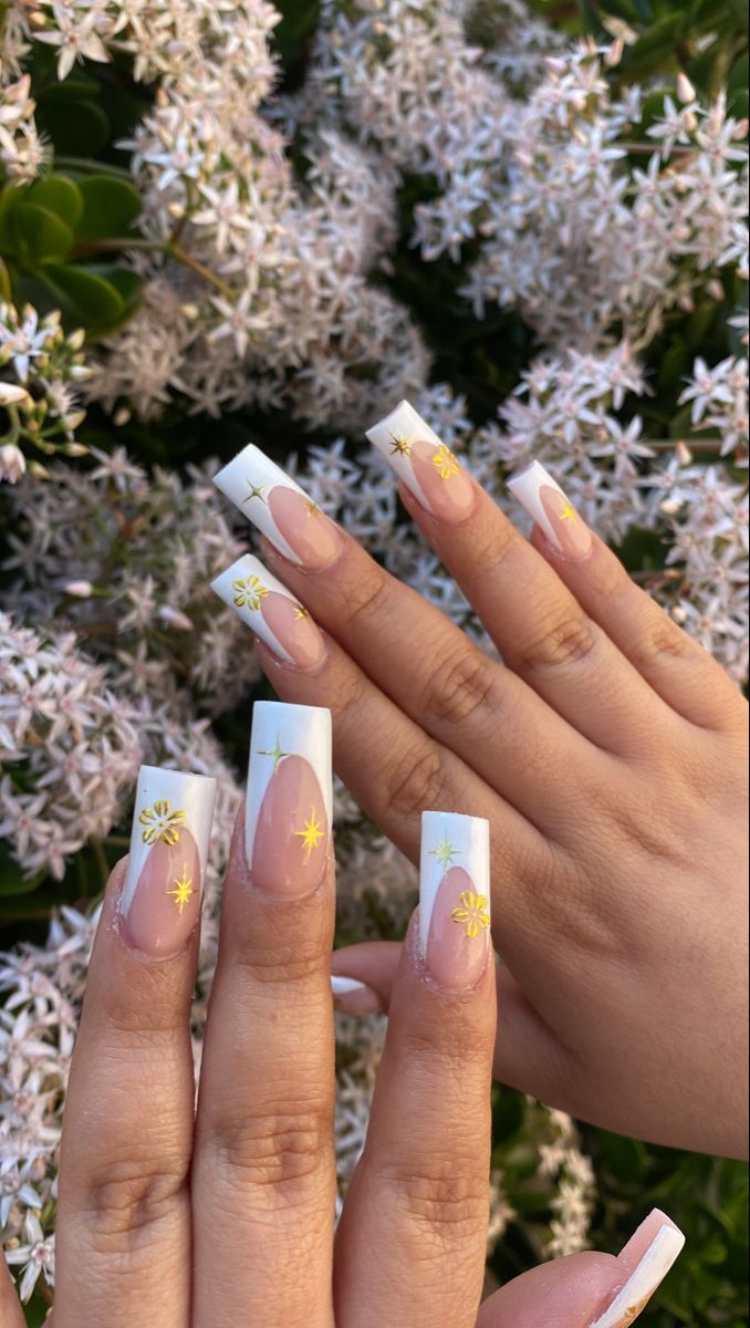 Charming Floral French Tip Nail Design with Playful Yellow Accents.