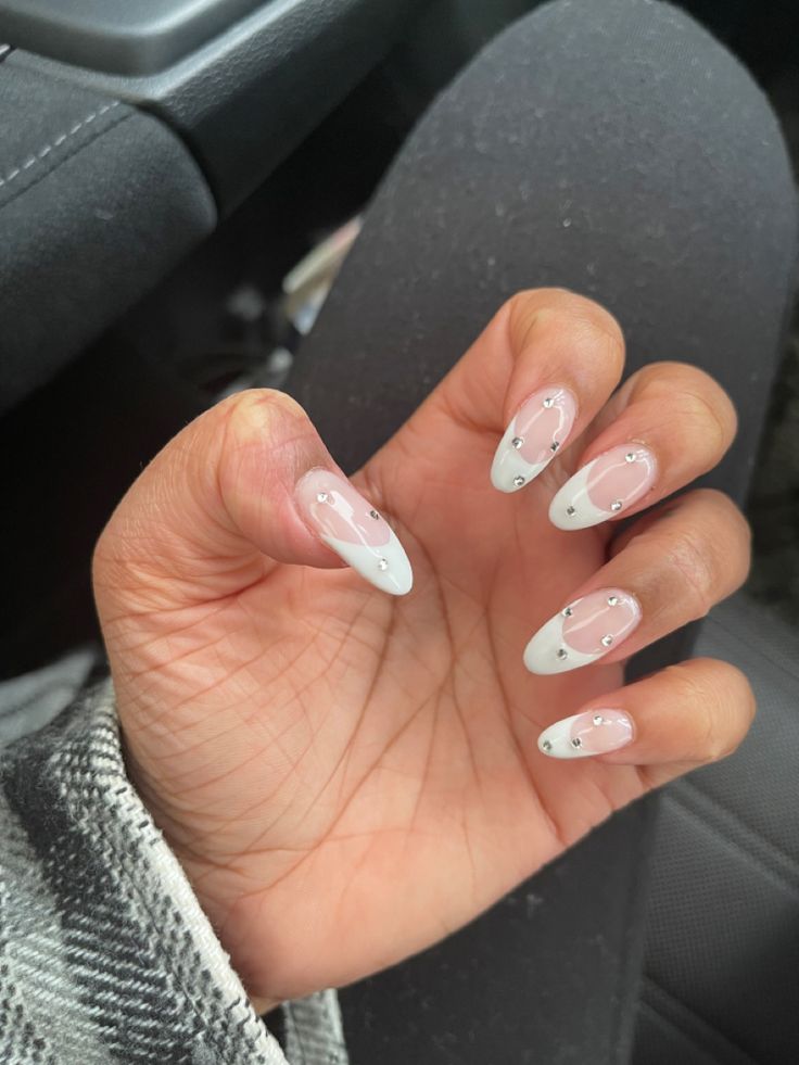 Sophisticated French Manicure with Soft Pink Base, White Tips, and Rhinestone Accents