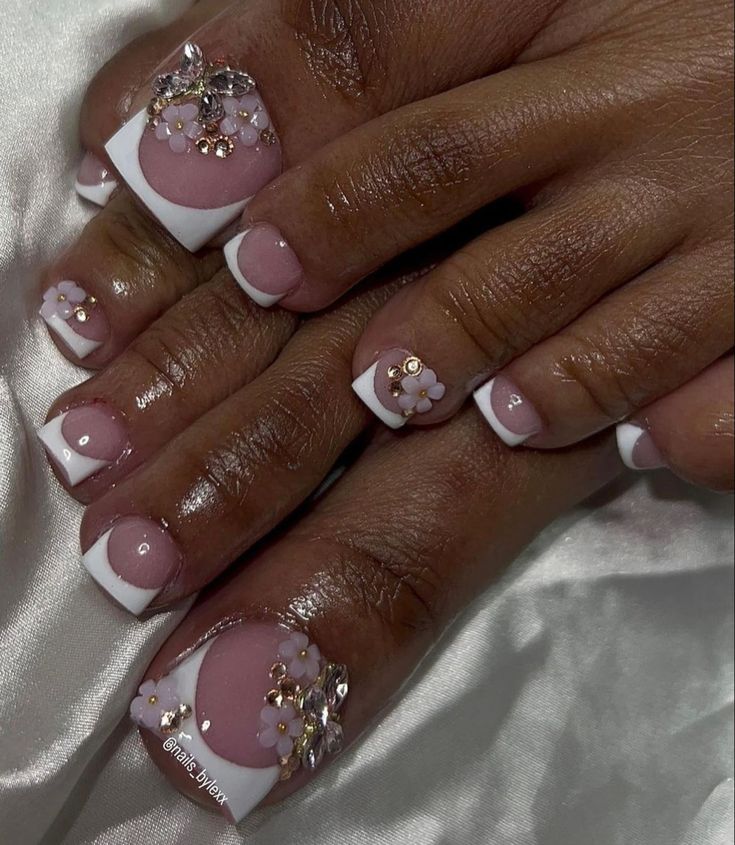 Sophisticated Soft Pink Nail Design with White Tips and Floral Accents