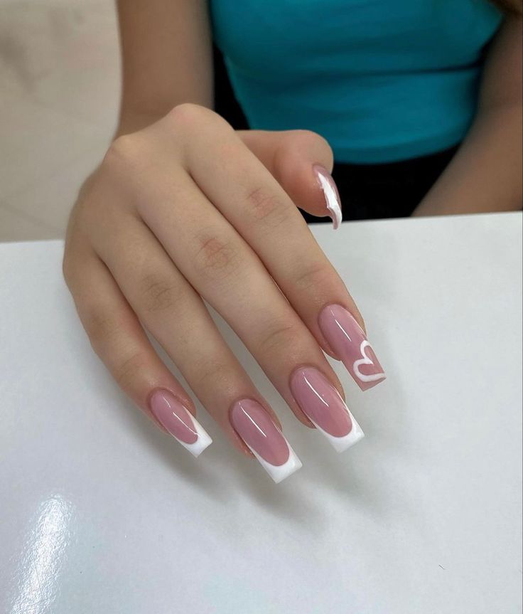 Sophisticated Soft Pink French Tip Nails with Playful Heart Accent.