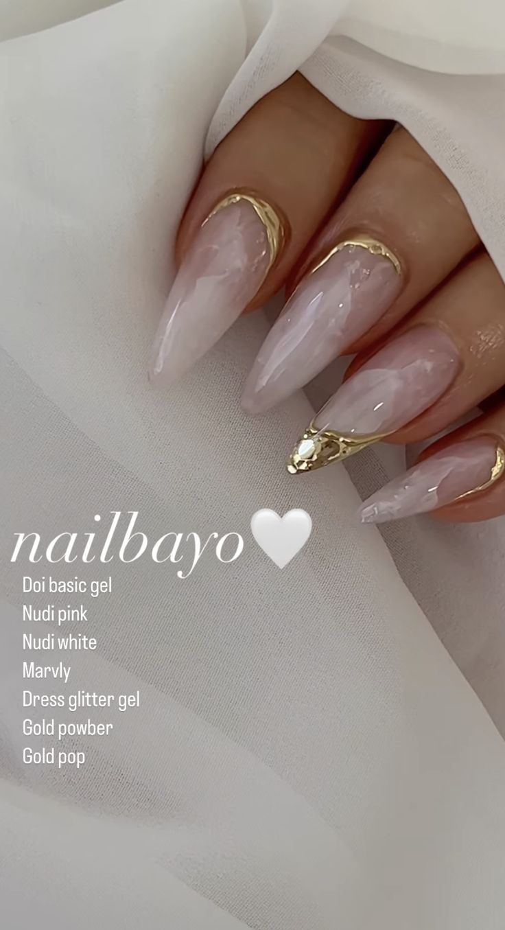 Sophisticated Almond-Shaped Nail Design with Nude Pink Base and Gold Accents.