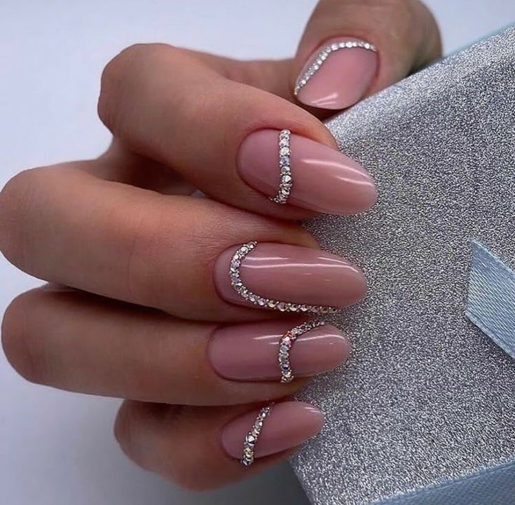 Elegant Nude Nail Design with Glamorous Rhinestone Accents.