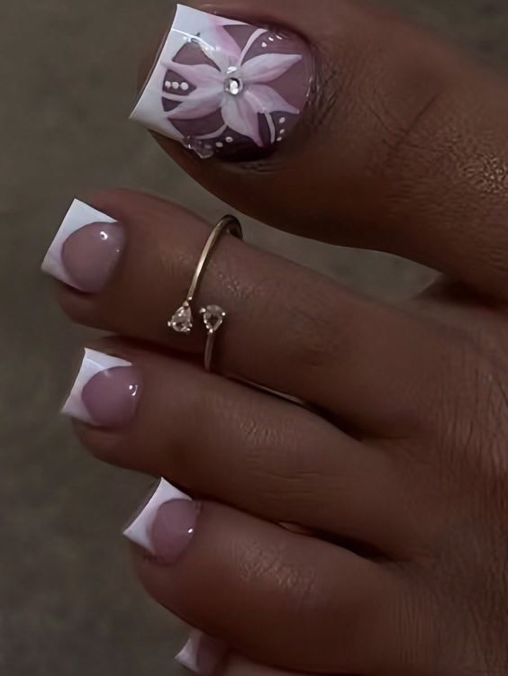 Sophisticated Nail Art: Classic French Tips with Intricate Floral Accents