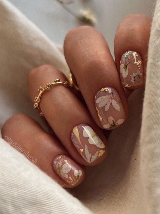 Elegant Floral Nail Design with Pastel Colors and Gold Accents.