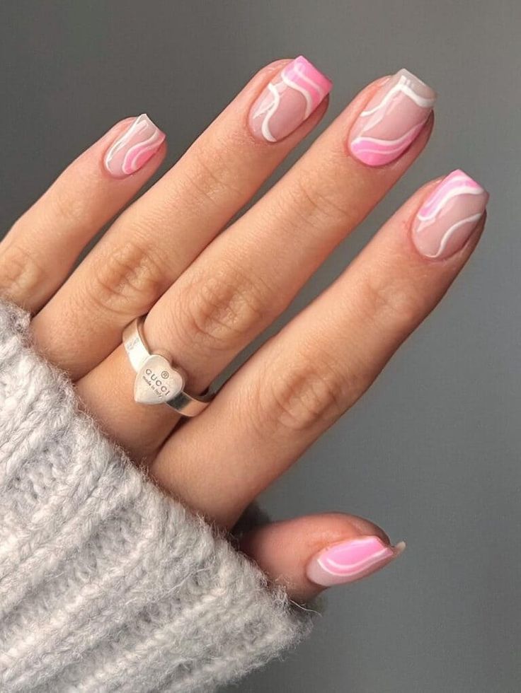 Stylish Nail Art: Soft Pink and White Swirl Design with Glossy Finish for a Sophisticated Look.