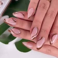 Sophisticated Almond-Shaped Nail Design with Nude Base and Metallic Accents.