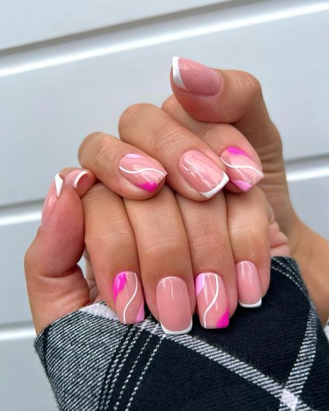 Elegant Nail Design: Classic French Tips with Modern Pink Accents and Playful Swirls.