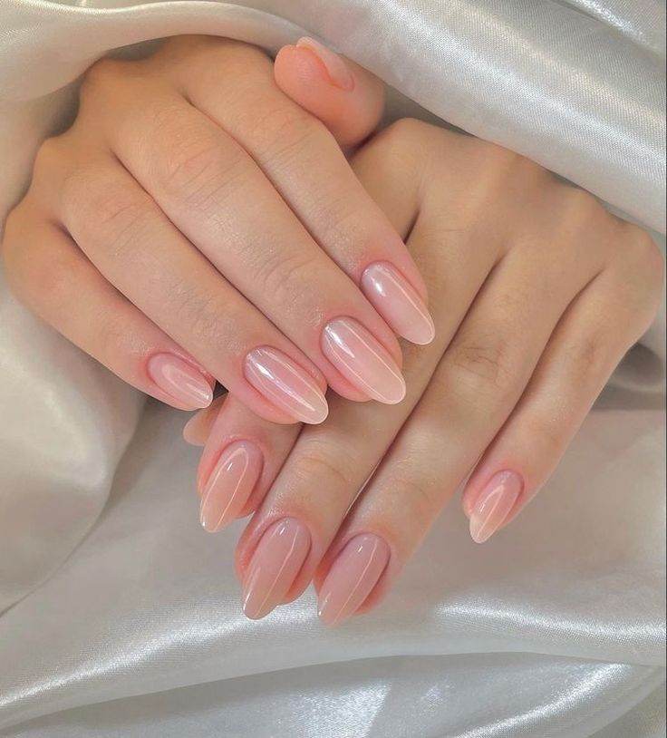 Elegant Almond-Shaped Nails with a Soft Ombre Effect in Subtle Pink Shades and Glossy Finish.