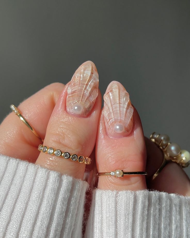 Elegant Nature-Inspired Nail Design with Translucent Leaf Patterns and Delicate Pearls.