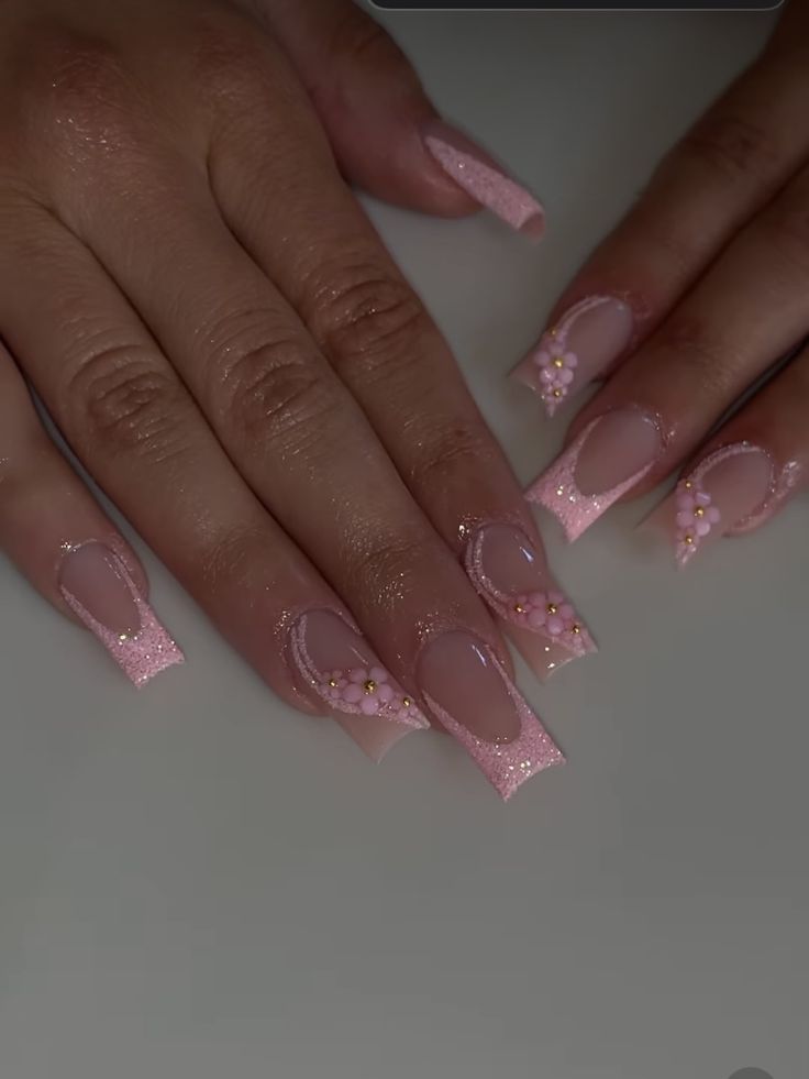 Stunning Pale Pink Acrylic Nails with Whimsical Designs for Sophisticated Playfulness.