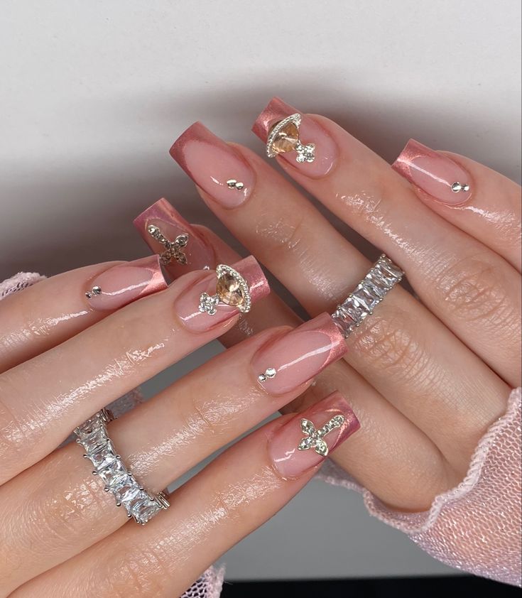 Sophisticated Glossy Nude Nails with Pink Ombre and Glamorous Gold/Silver Accents.