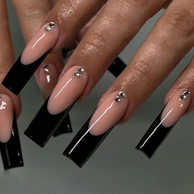 Chic Elongated Nail Design: Nude and Glossy Black with Elegant Rhinestones