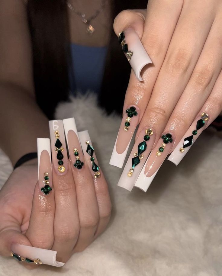 Elegant Long Square Nail Design with White and Nude Palette, Embellished with Gems and Gold Beads.