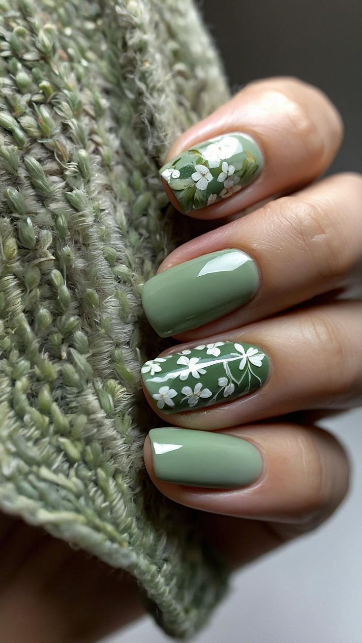 Refreshing Green Nail Design with Glossy Finishes and Whimsical Floral Patterns.