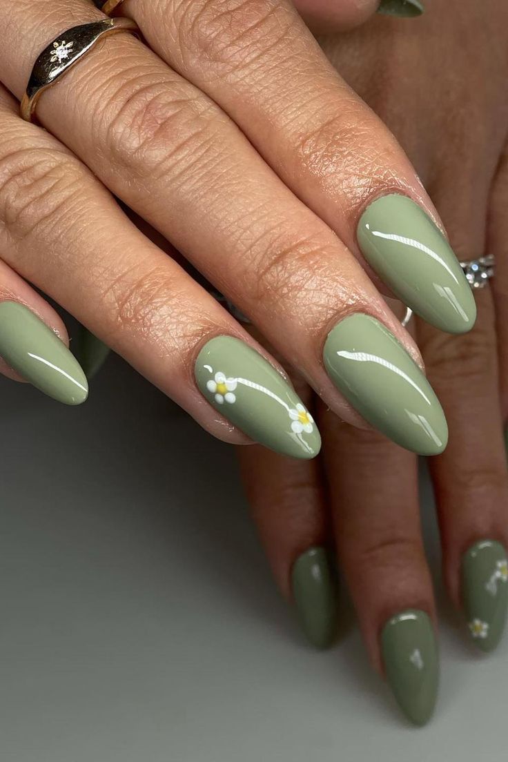 Chic Olive Green Almond Nails Adorned with Elegant White Floral Accents.